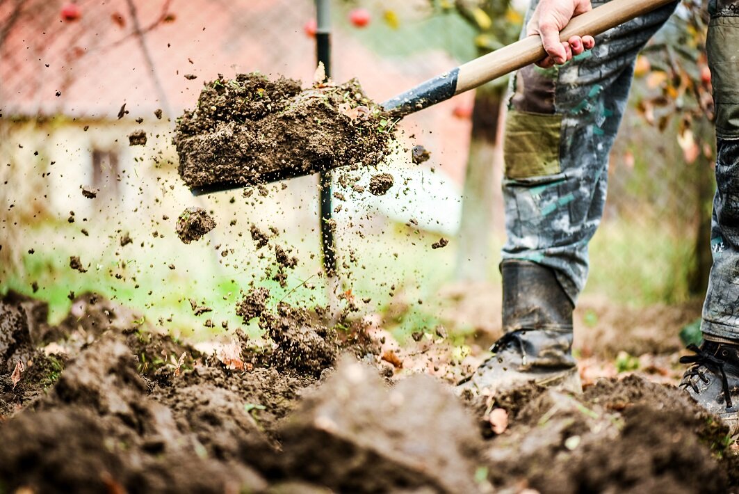 Gartenarbeit mit Schaufel beim Verteilen von Erde | © stock.adobe.com
